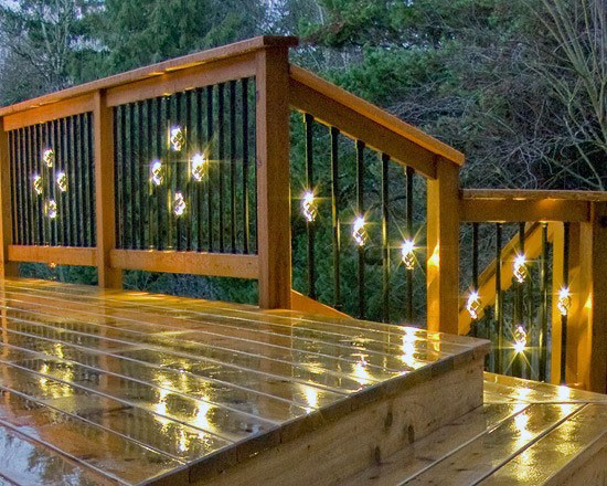 An expansive, newly remodeled deck by Zenith Builders boasts robust, espresso-hued decking that seamlessly extends the living space into the outdoors, complemented by durable railings that promise safety without sacrificing style